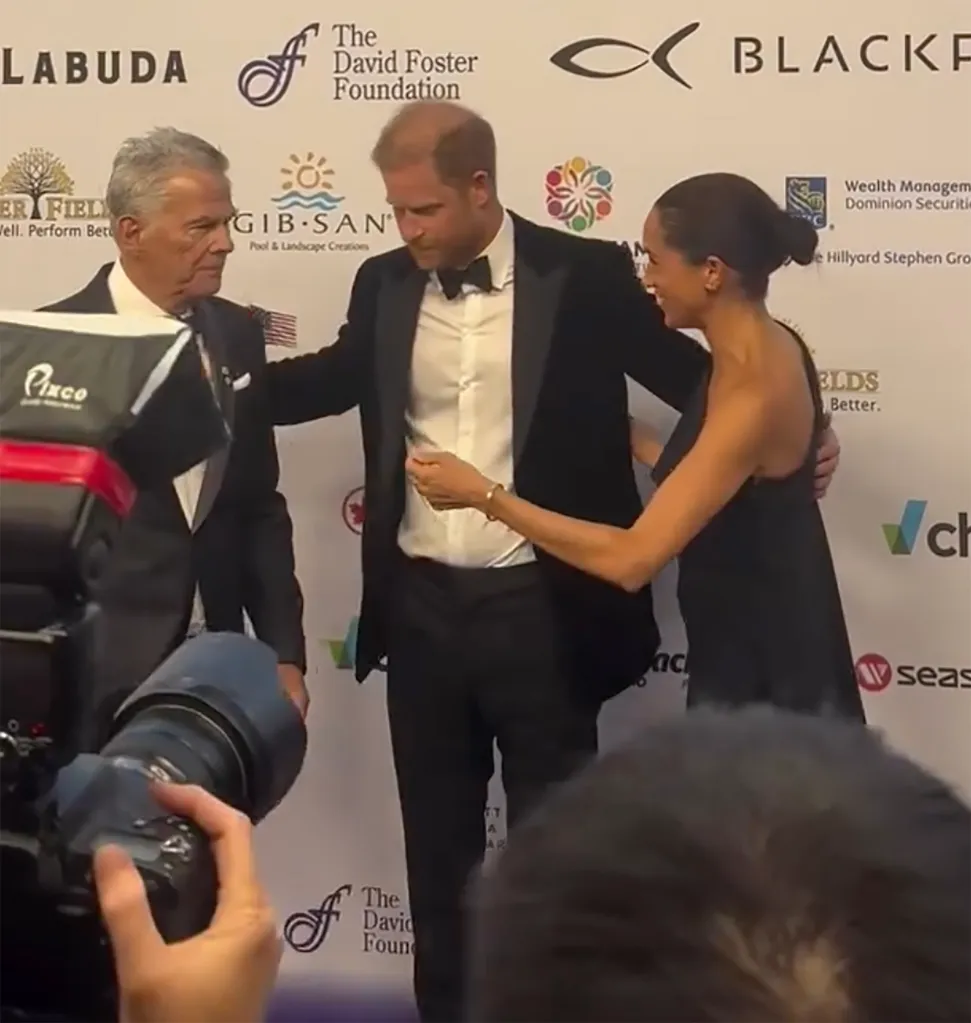 Meghan Markle interacting with David Foster and Prince Harry at an event.