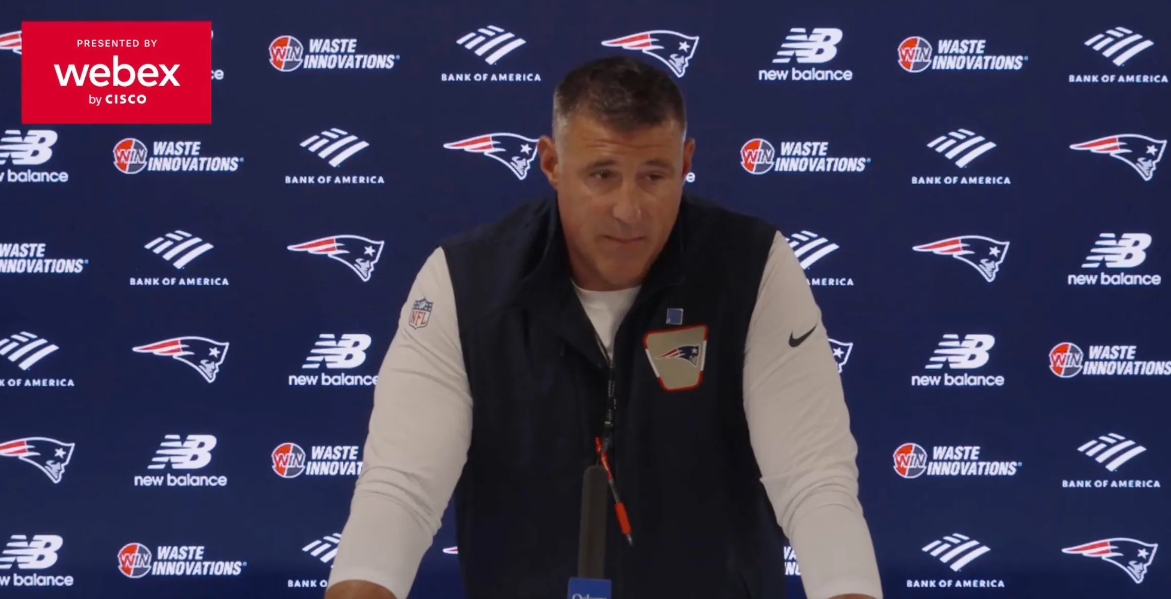 Mike Vrabel answering questions at a press conference.