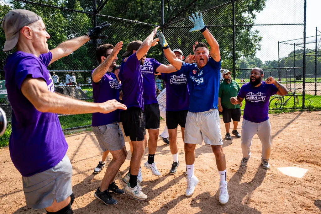 Nick Swisher celebrates with the Sons of Pitches softball team.