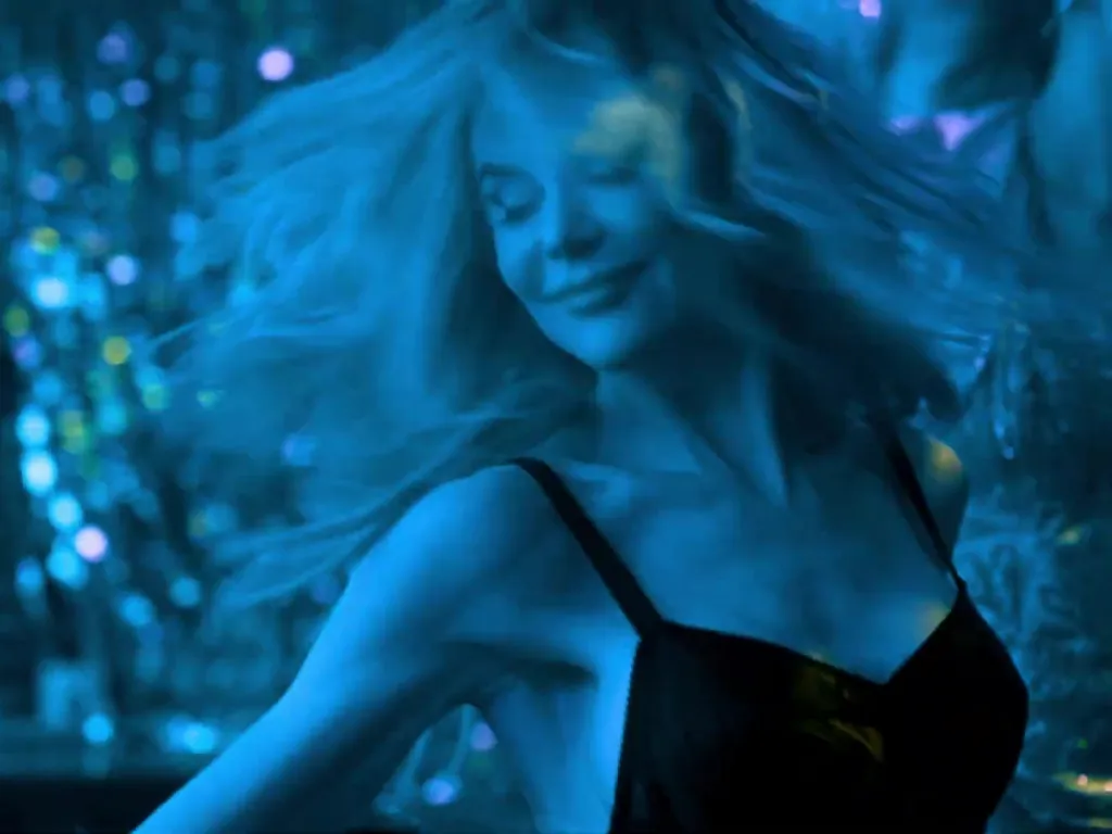 Nicole Kidman dancing in a music video, bathed in blue light.