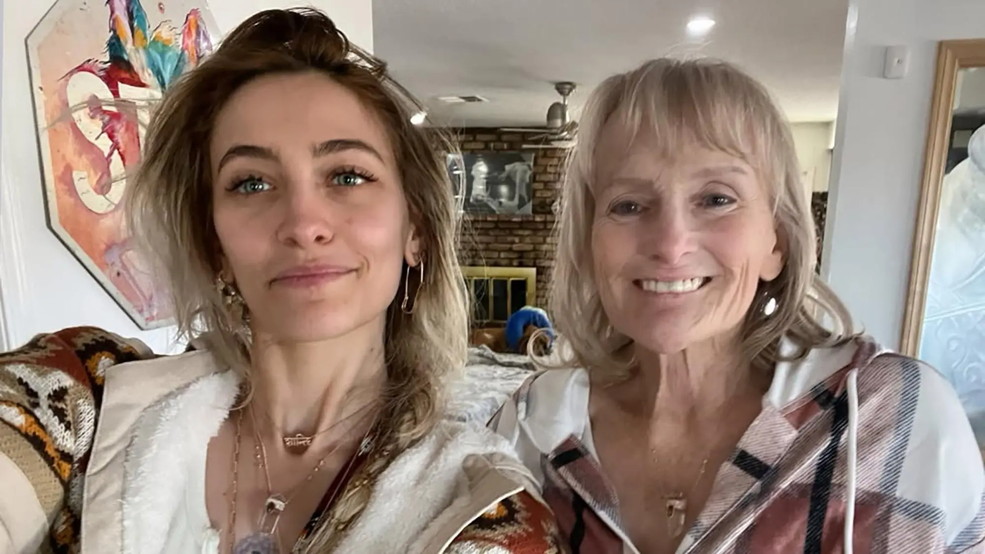 Paris Jackson and her mother Debbie Rowe smiling at the camera.
