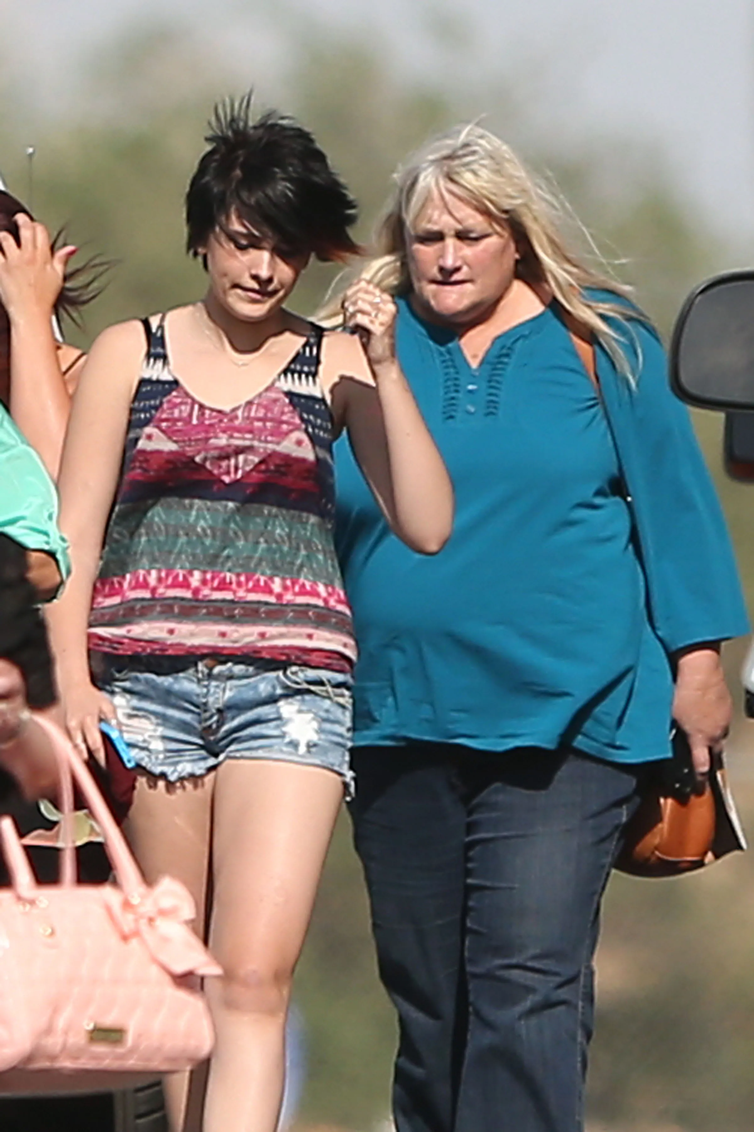 Paris Jackson and Debbie Rowe walking together outdoors.