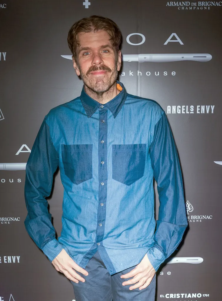 Perez Hilton posing in a denim shirt at the BOA Steakhouse Grand Opening Celebration.