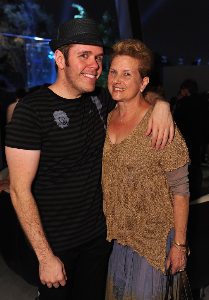 Perez Hilton and his mother attending the grand opening of a new BOA Steakhouse.