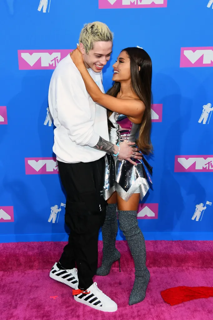 Pete Davidson and Ariana Grande embrace on the red carpet.