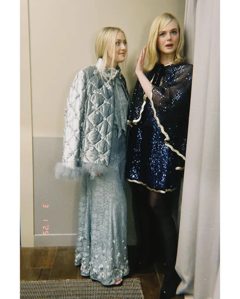 Dakota and Elle Fanning posing together, Dakota in a quilted jacket and long skirt, Elle in a sequined mini-dress.