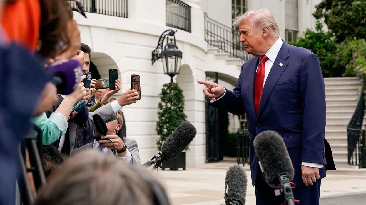 Trump fondles tree photos in front of baffled reporter: ‘There is no precedent’