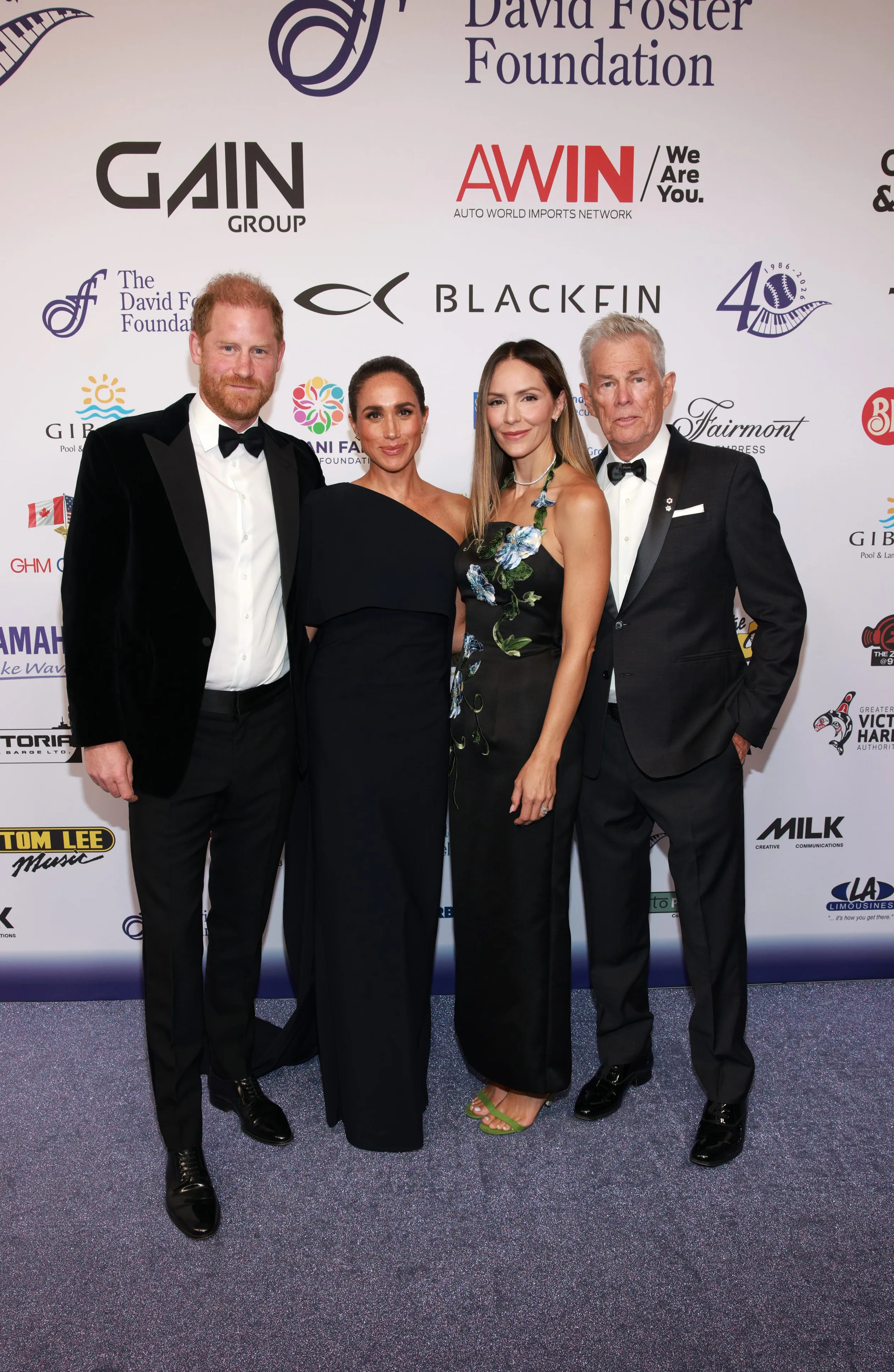 Prince Harry, Meghan Markle, Katharine McPhee, and David Foster pose at the David Foster Foundation 40th Anniversary Celebration.