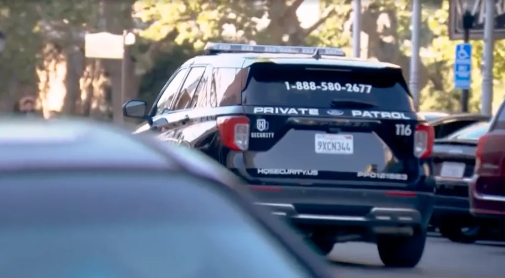 Back of a black private security patrol SUV with "1-888-580-2677", "PRIVATE PATROL", "HQ SECURITY", and "HQSECURITY.US" printed on it.
