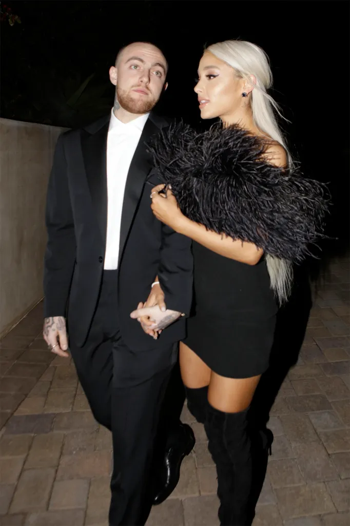 Rapper Mac Miller and singer Ariana Grande walking while holding hands.