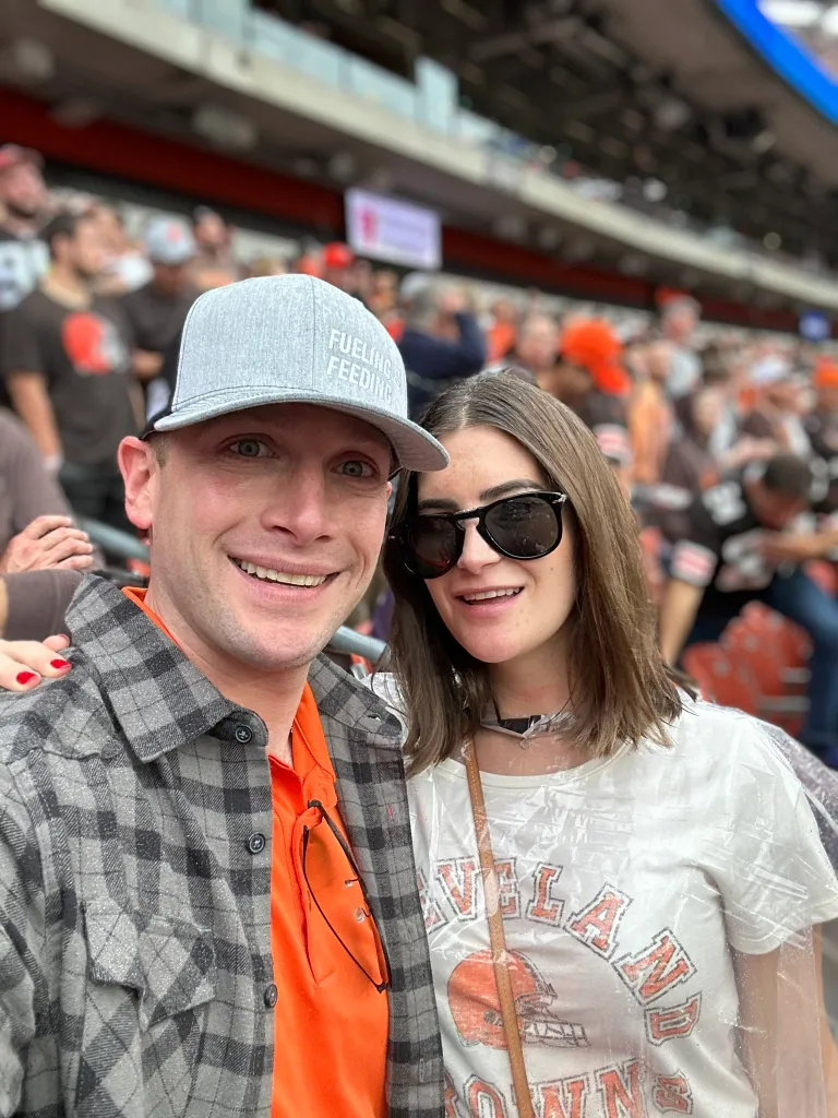 Rep. Max Miller and his now ex-wife Emily Moreno smiling at a sporting event.