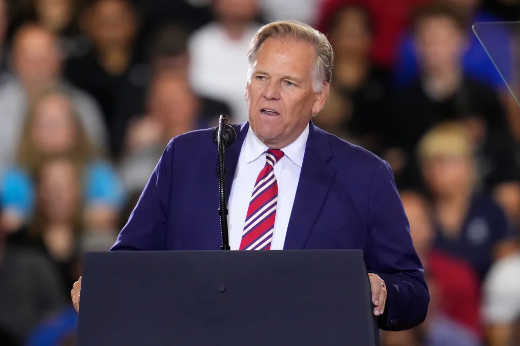 Republican Senate candidate Mike Rogers speaking at a podium.