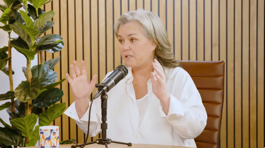 Rosie O'Donnell speaking into a microphone.