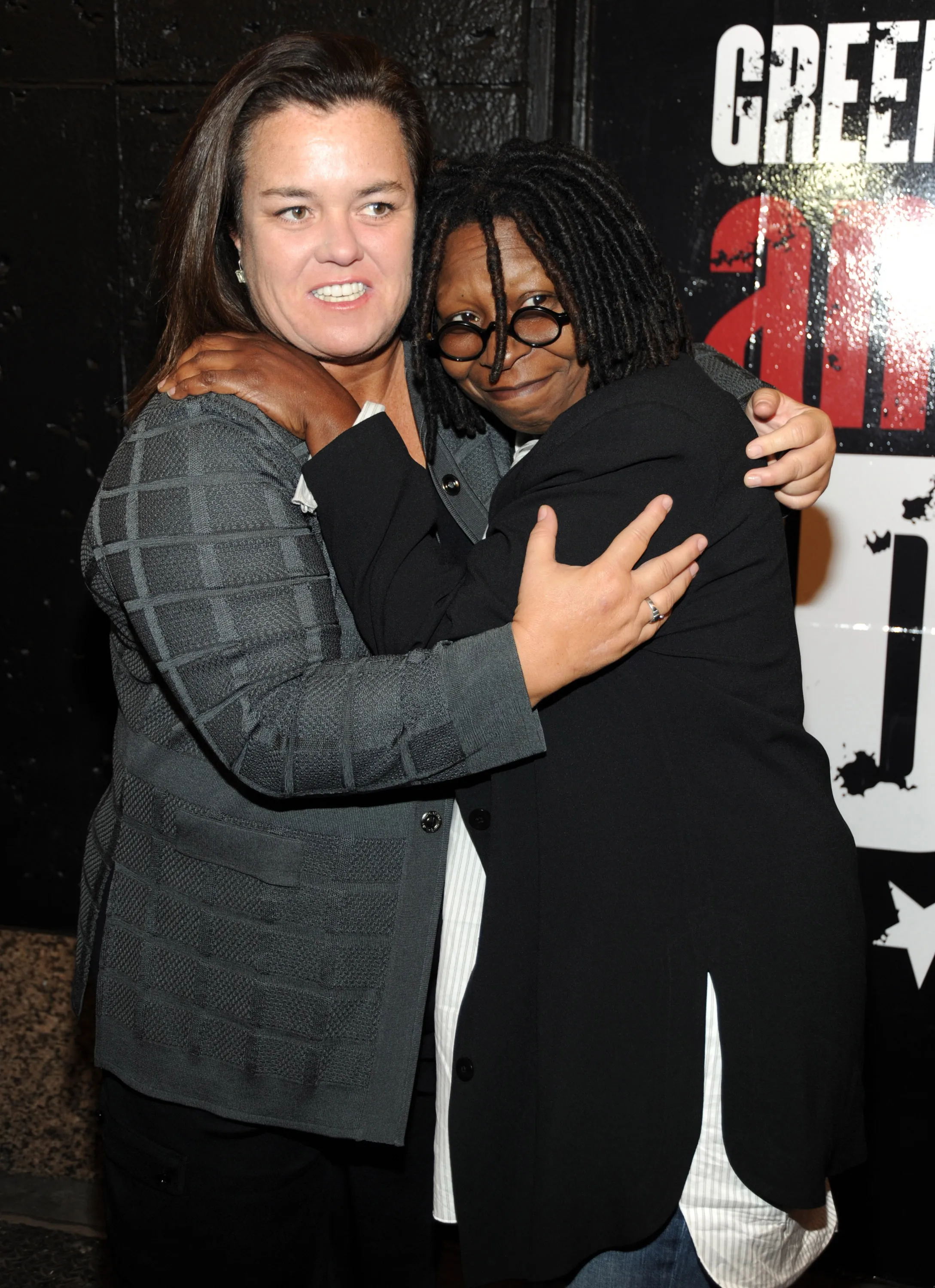 Rosie O'Donnell and Whoopi Goldberg embracing.