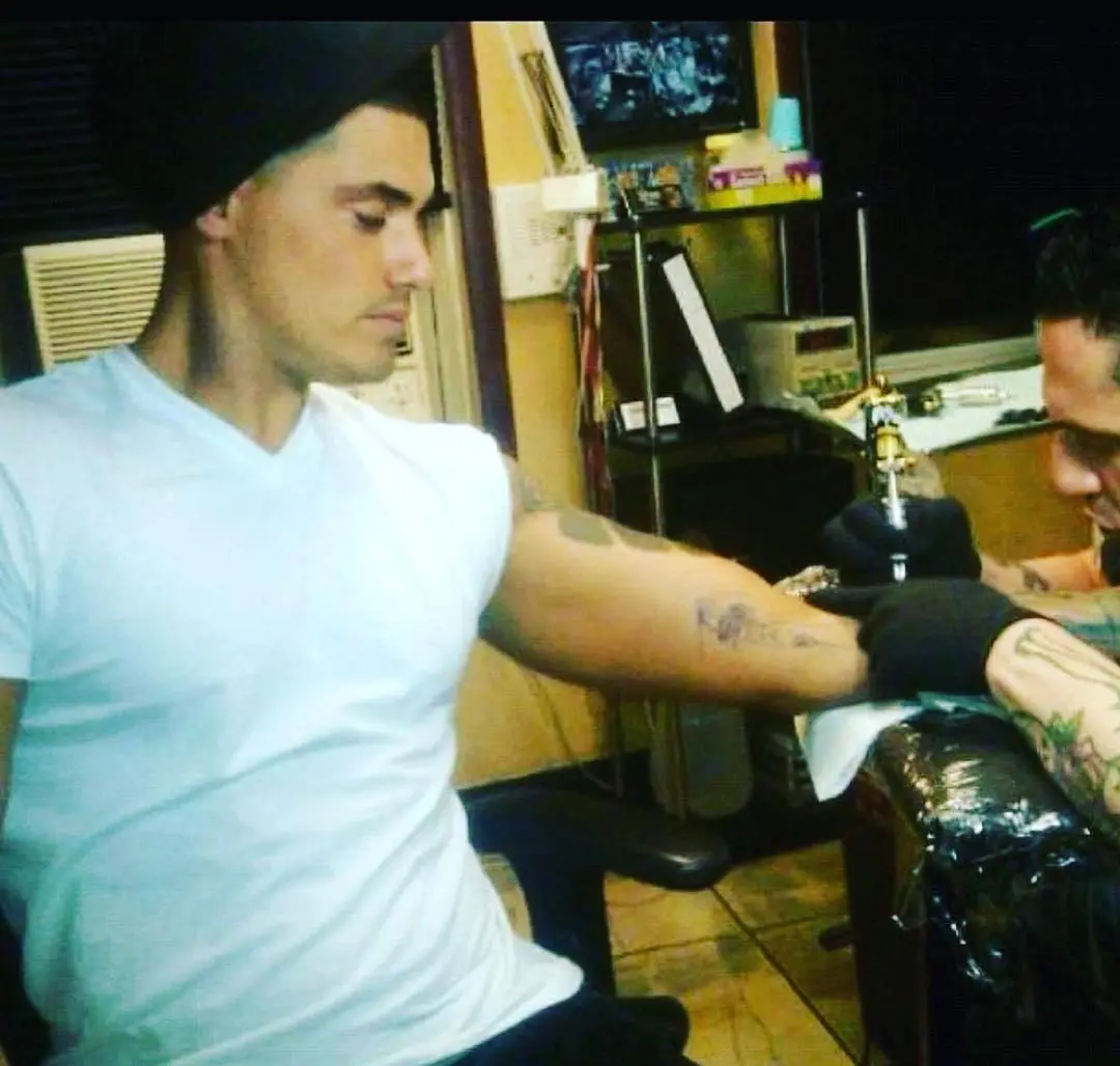 Ryan De Nino getting a tattoo on his arm.