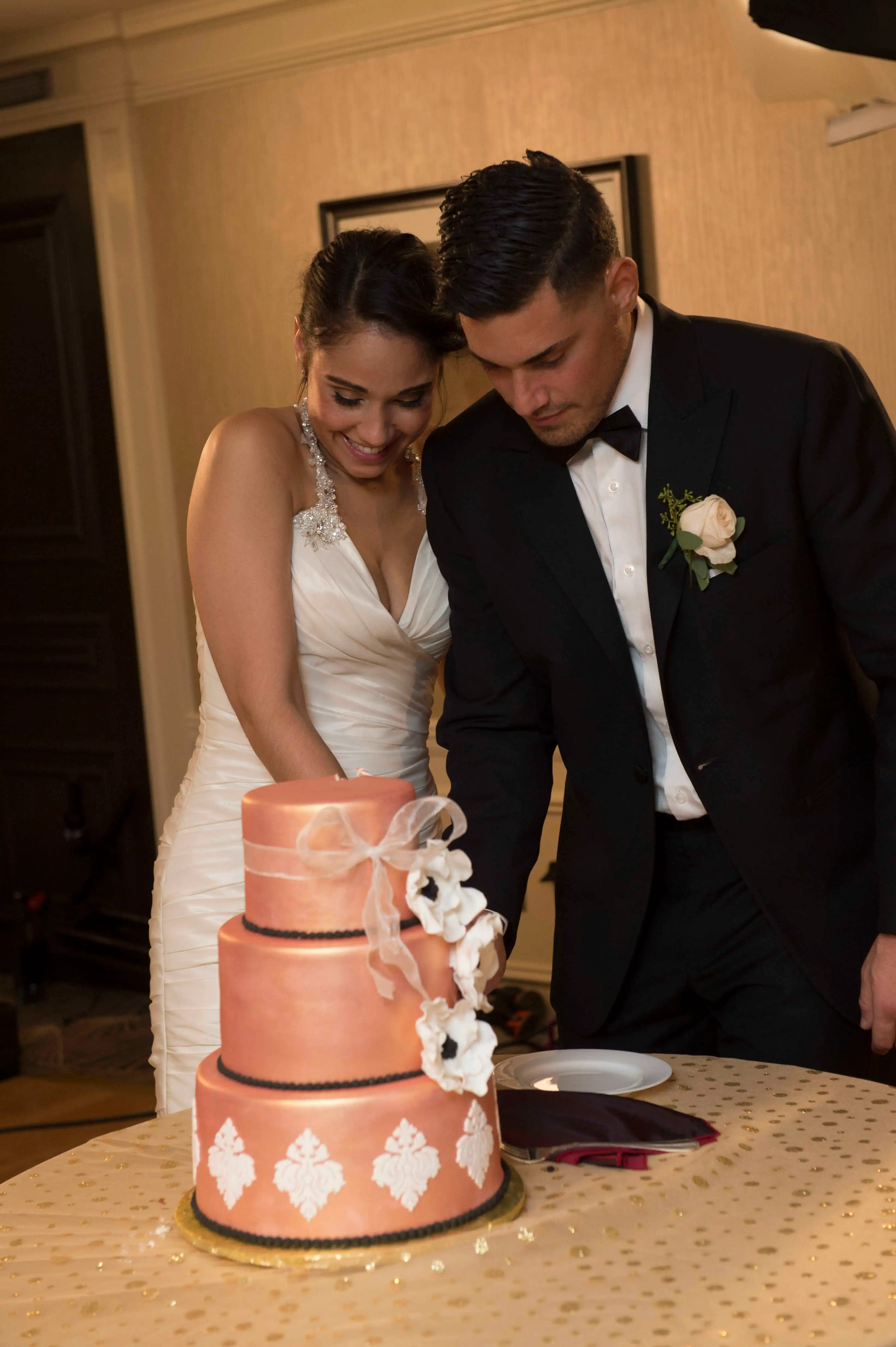 Jessica Castro and Ryan De Nino cutting their wedding cake.