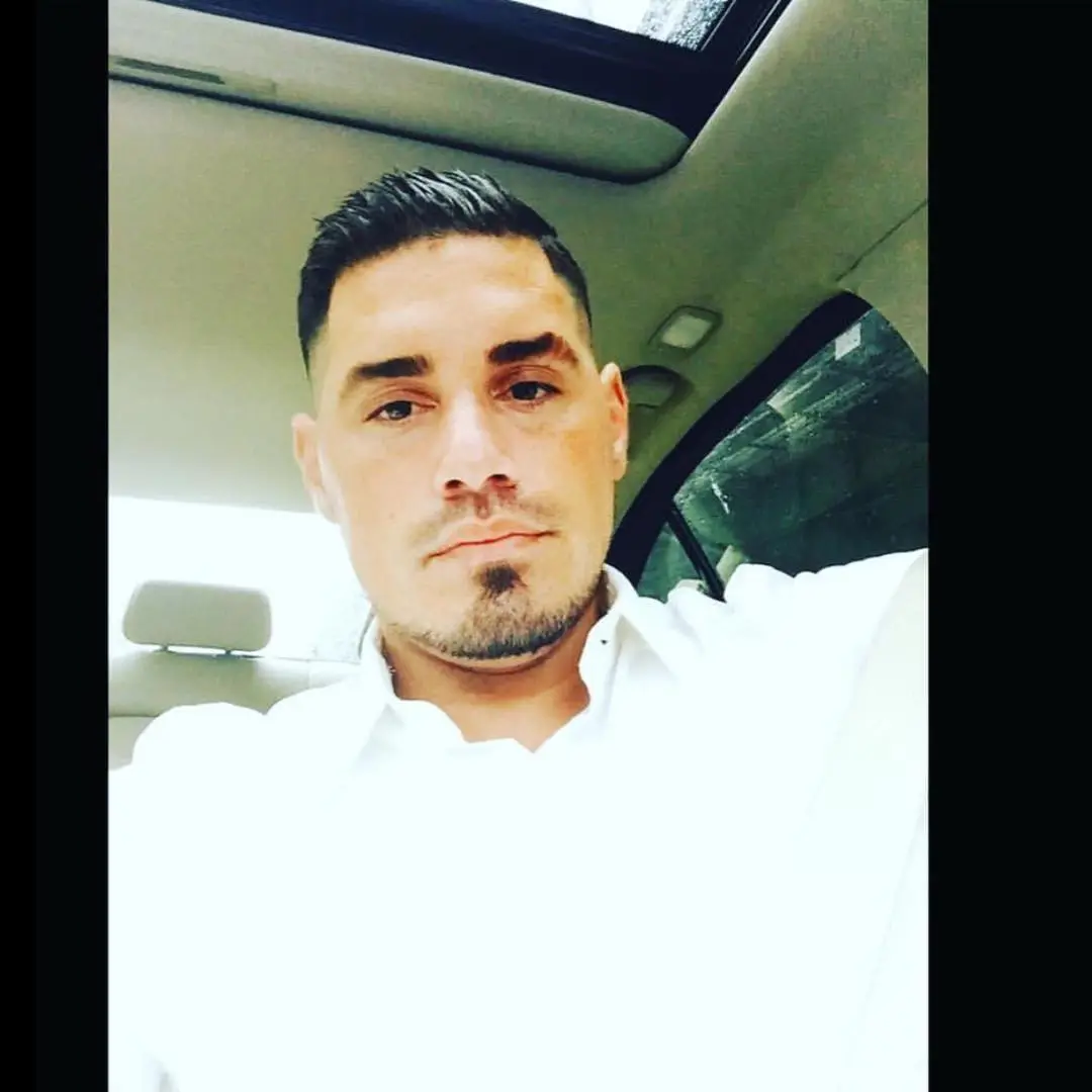 Ryan De Nino looking at the camera in a car.