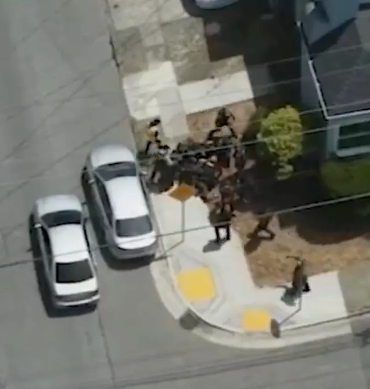 Drone footage of deputies tackling a suspect attempting to flee.