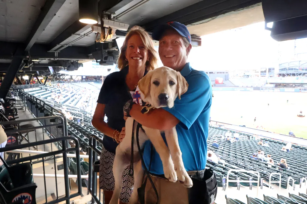 Sarah and Bob Zagaja pose with "Howie," a future service dog of American VetDogs, Friday, July 31, 2026, at Citi Field in Queens, NY. (Robert Sabo for NY Post)