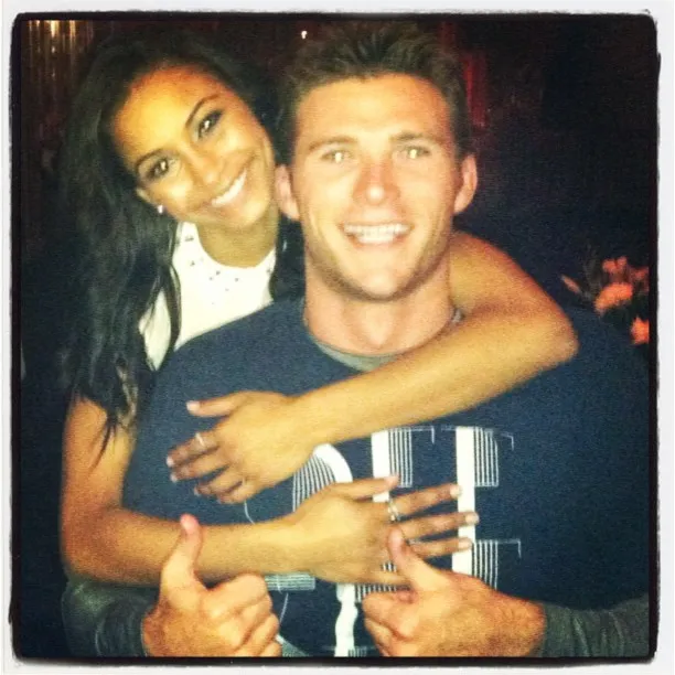 Scott Eastwood and Jewel Brangman smiling, with Brangman hugging Eastwood from behind.