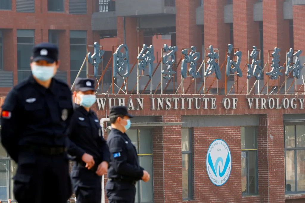 Security personnel in face masks stand outside the Wuhan Institute of Virology.
