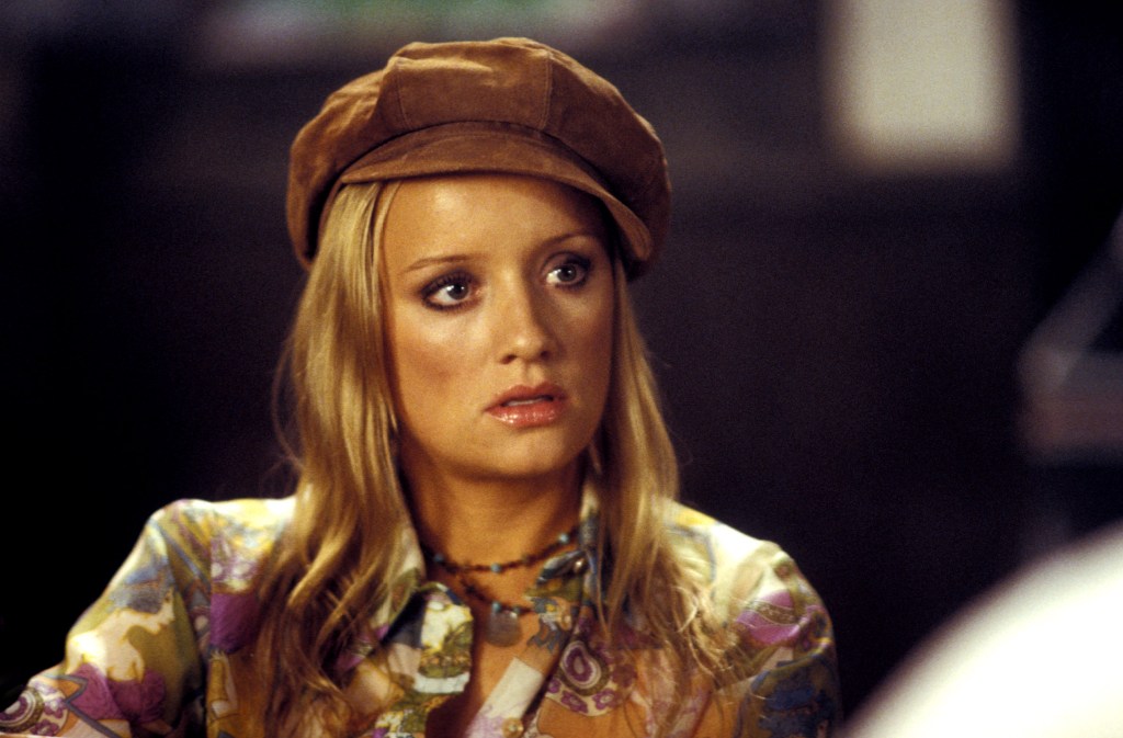 Lucy Davis in "Shaun of the Dead" (2004) wearing a brown cap and patterned shirt.