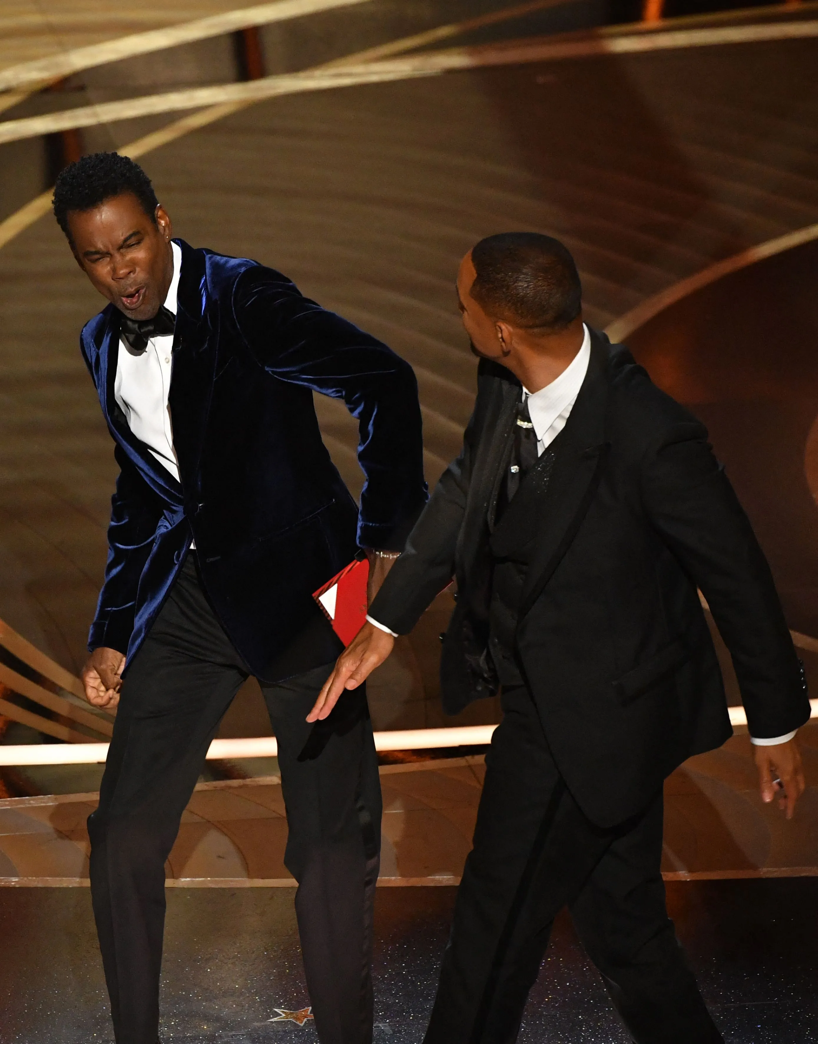 US actor Will Smith (R) slaps US actor Chris Rock onstage during the 94th Oscars.