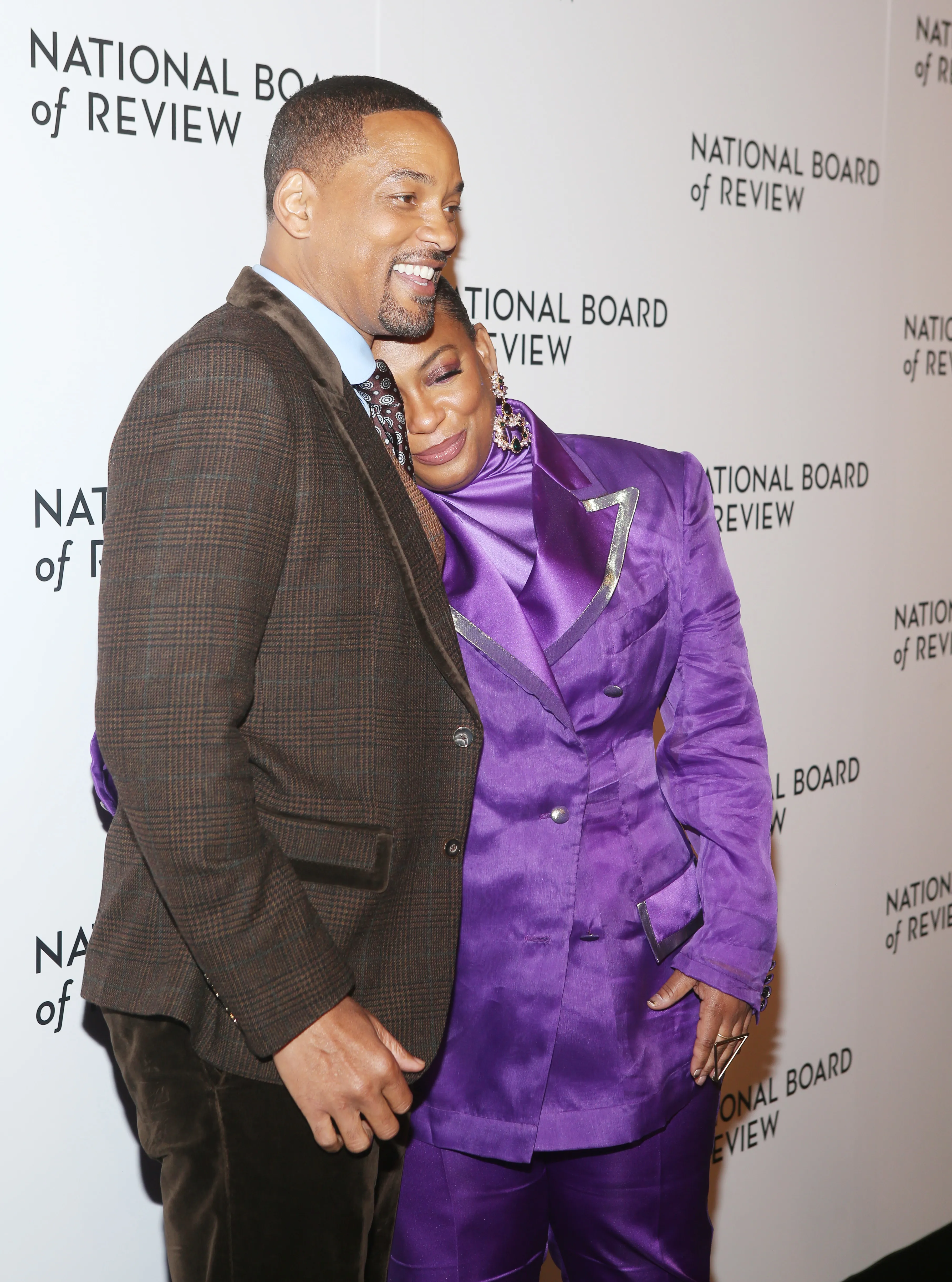 Will Smith smiling as Aunjanue Ellis leans her head on his shoulder.