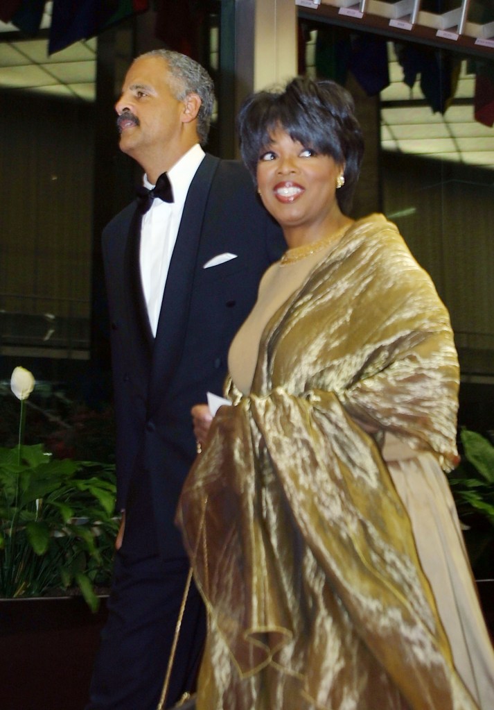 Oprah Winfrey in a gold gown and shawl with Stedman Graham in a tuxedo at the Kennedy Center Honors.