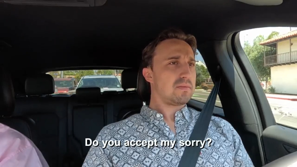 Thomas from 90 Day Fiance in a car, asking "Do you accept my sorry?"