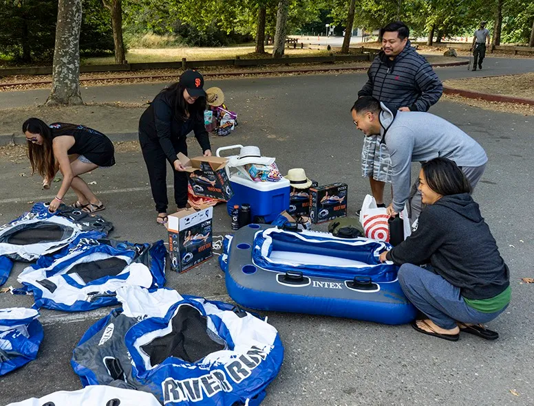 A group of people prepare their inflatable tubes for a trip down the Russian River.