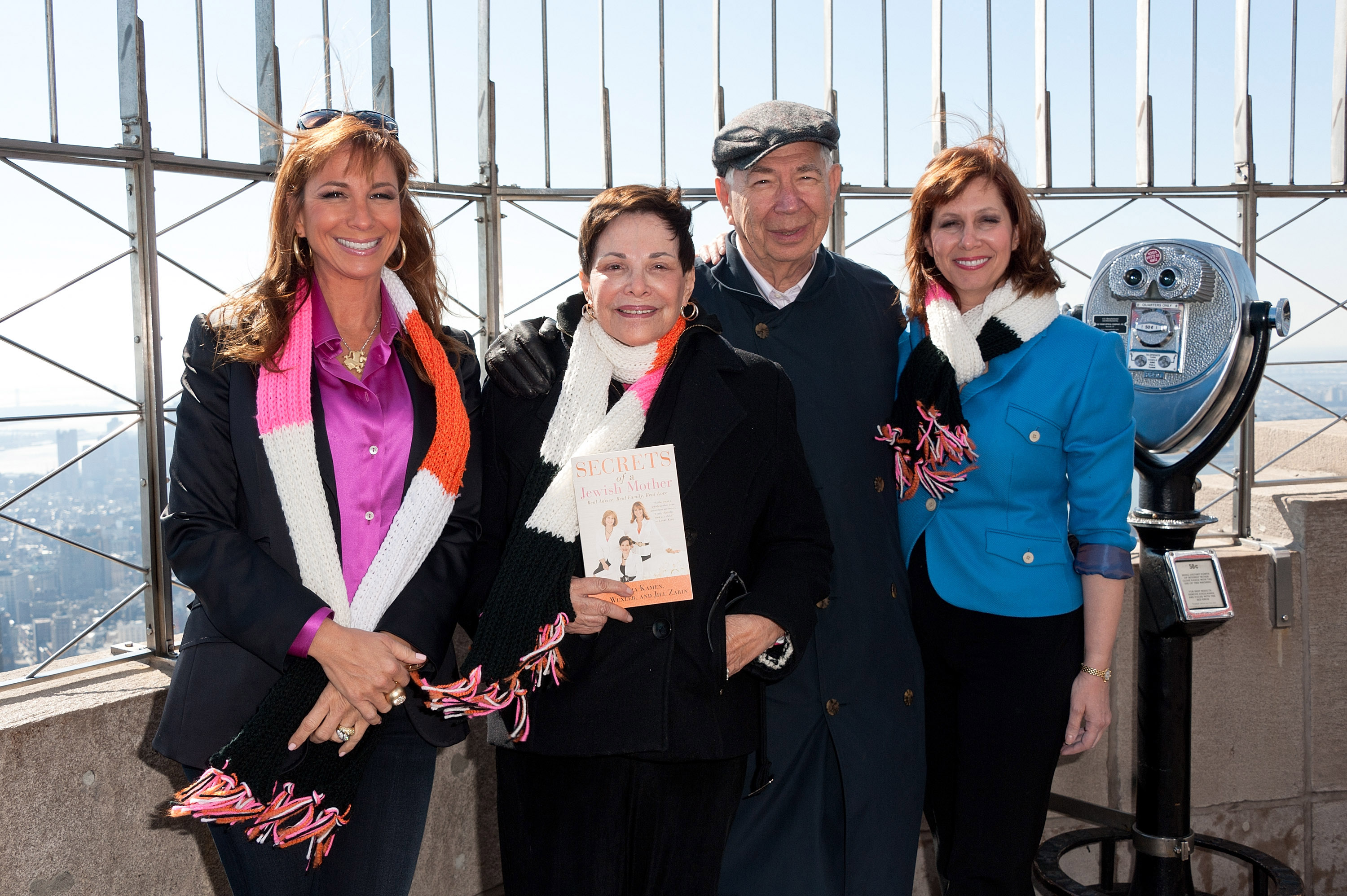 Jill Zarin, Gloria Kamen, Sol Kamen, and Lisa Wexler pose with the book "Secrets of a Jewish Mother" at the Empire State Building.
