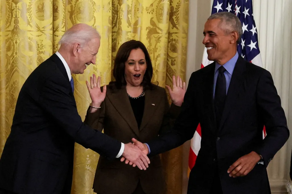 President Joe Biden greets former President Barack Obama and Vice President Kamala Harris during an event in the East Room of the White House on April 5, 2022.