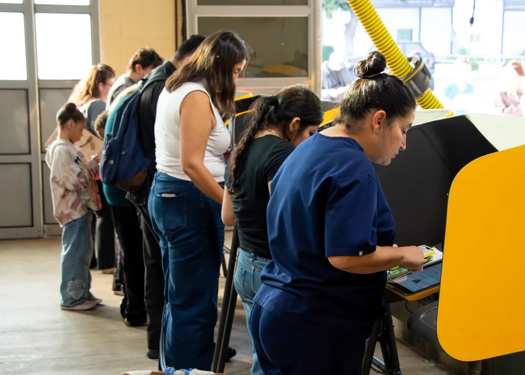 People lining up to cast their ballots at a polling place.