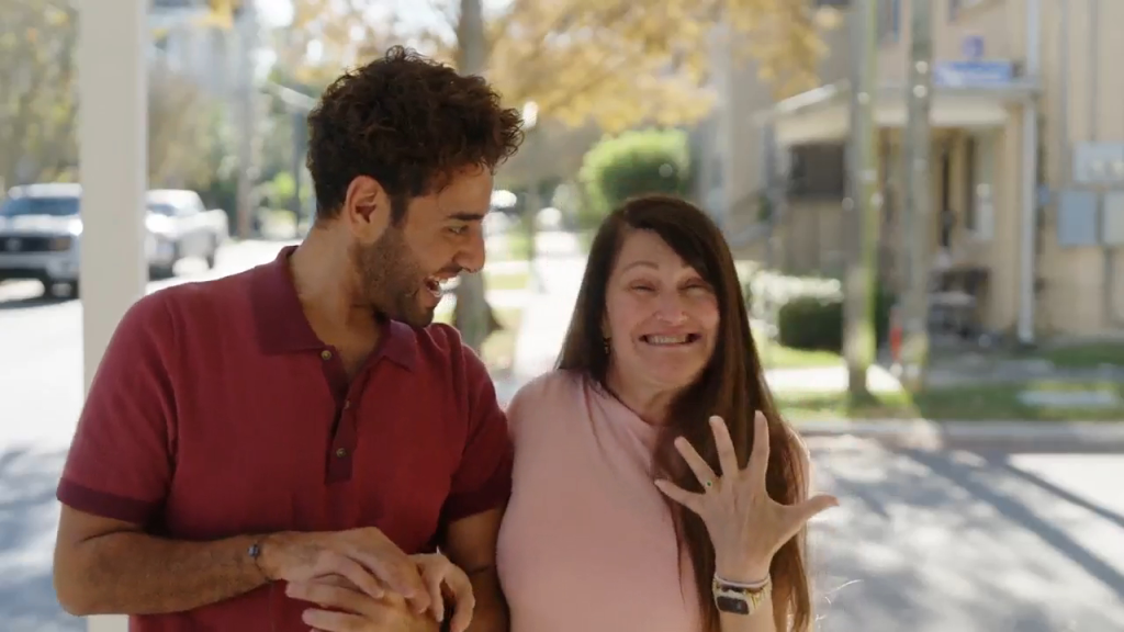 A man and woman reacting with surprise and joy.