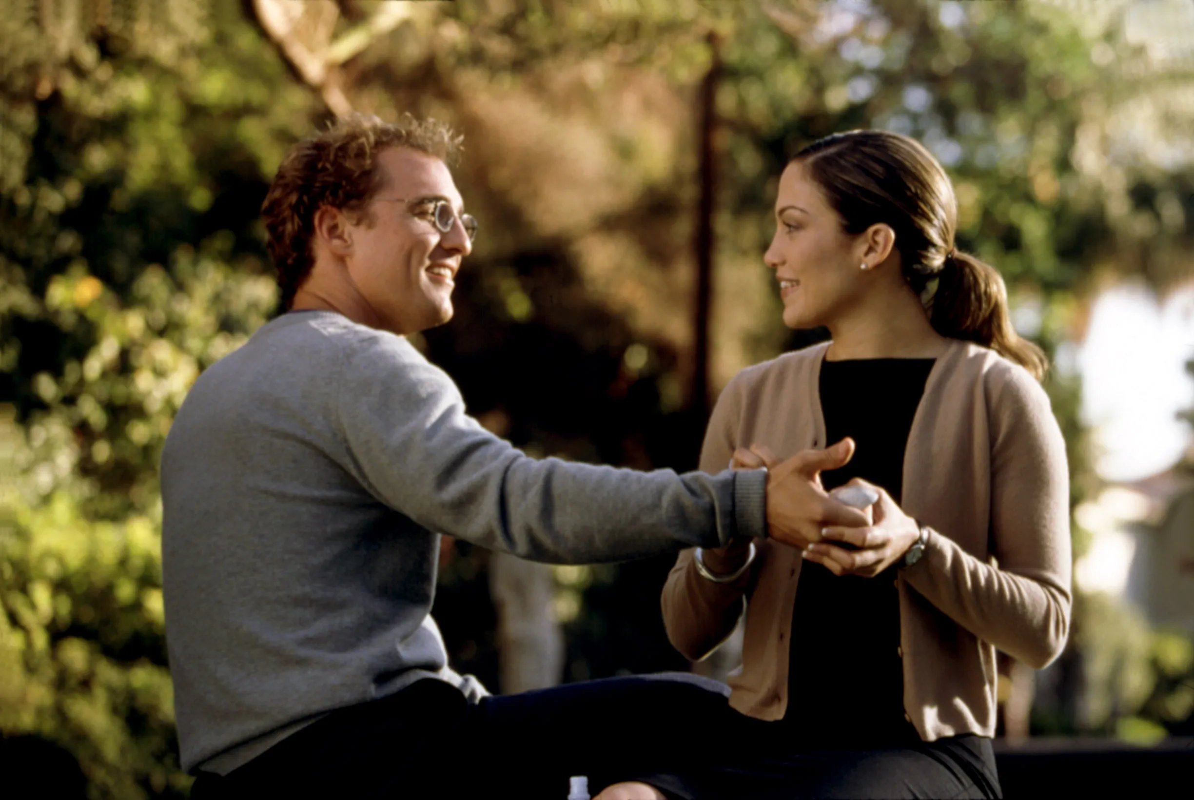 Matthew McConaughey holding Jennifer Lopez's hand in The Wedding Planner.