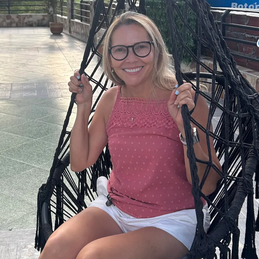 Magnolia Garcia Lugo smiling while sitting in a hanging chair.
