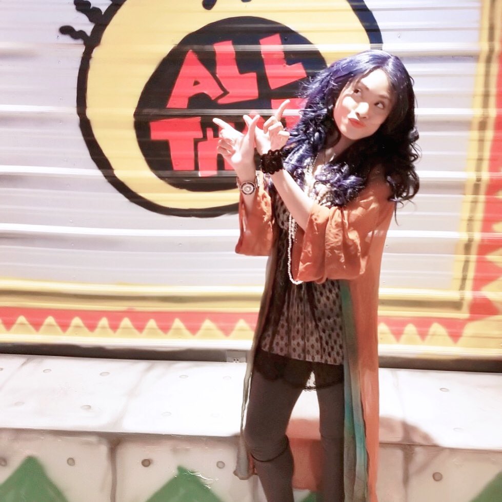 Christy Knowings posing in front of an "All That" logo.