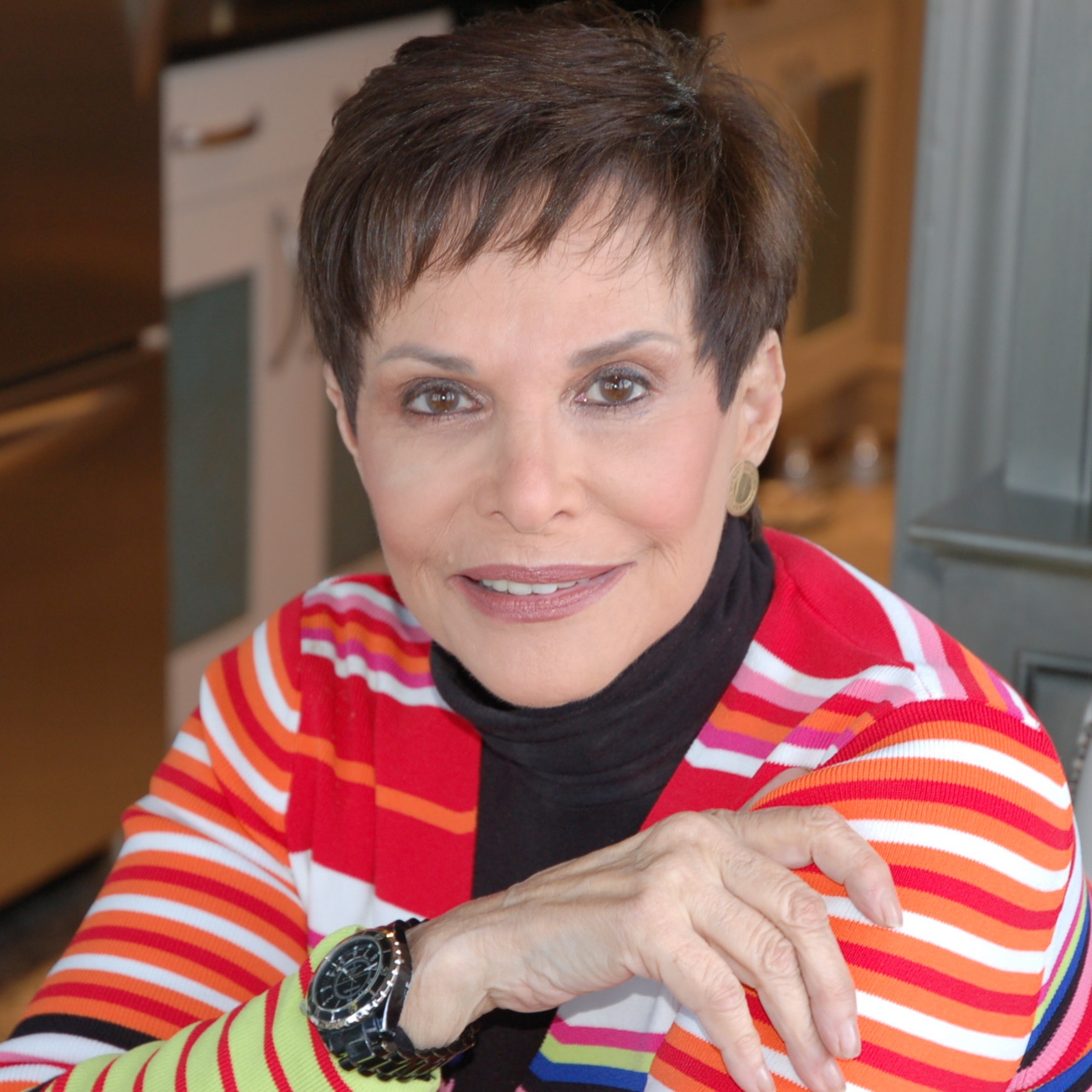 Jill Zarin's mother Gloria in a red, white, and orange striped sweater.