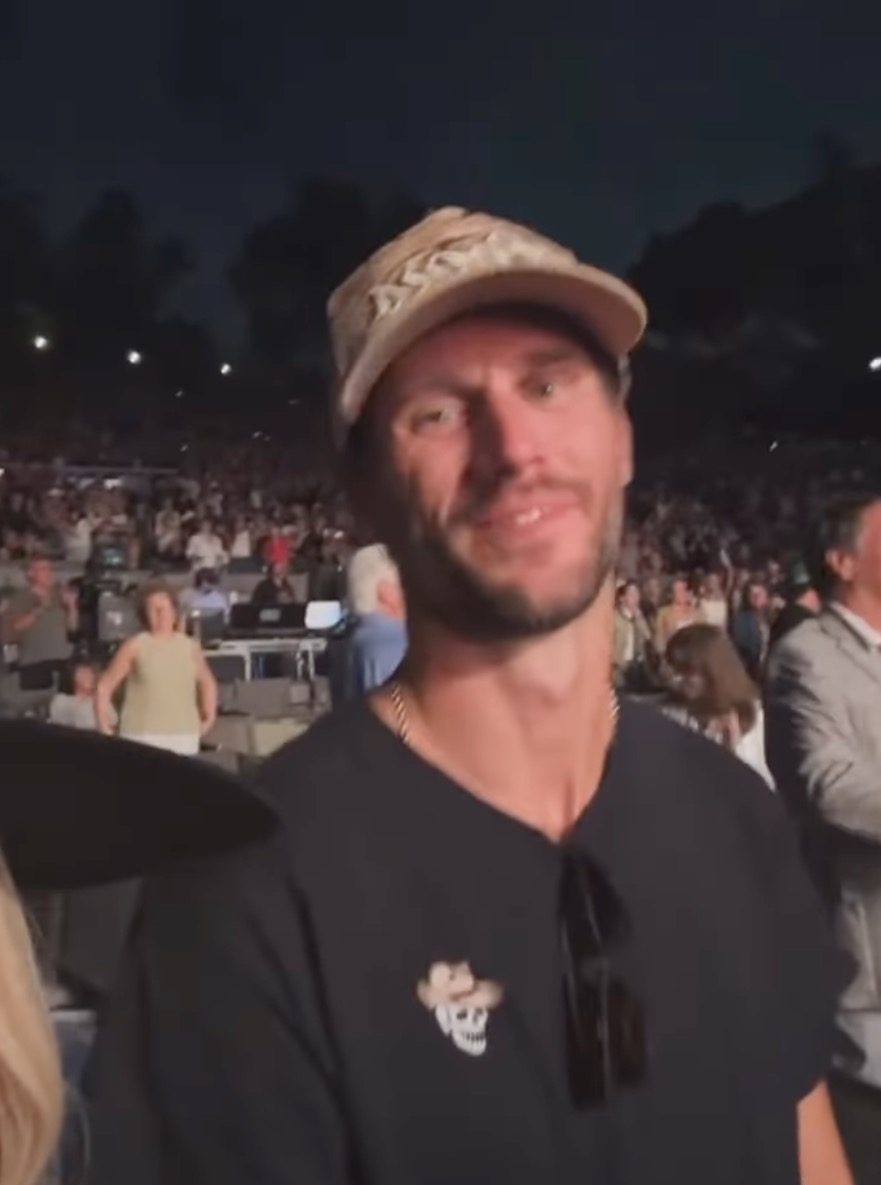PJ Conley wearing a baseball cap and a t-shirt with a skull graphic.