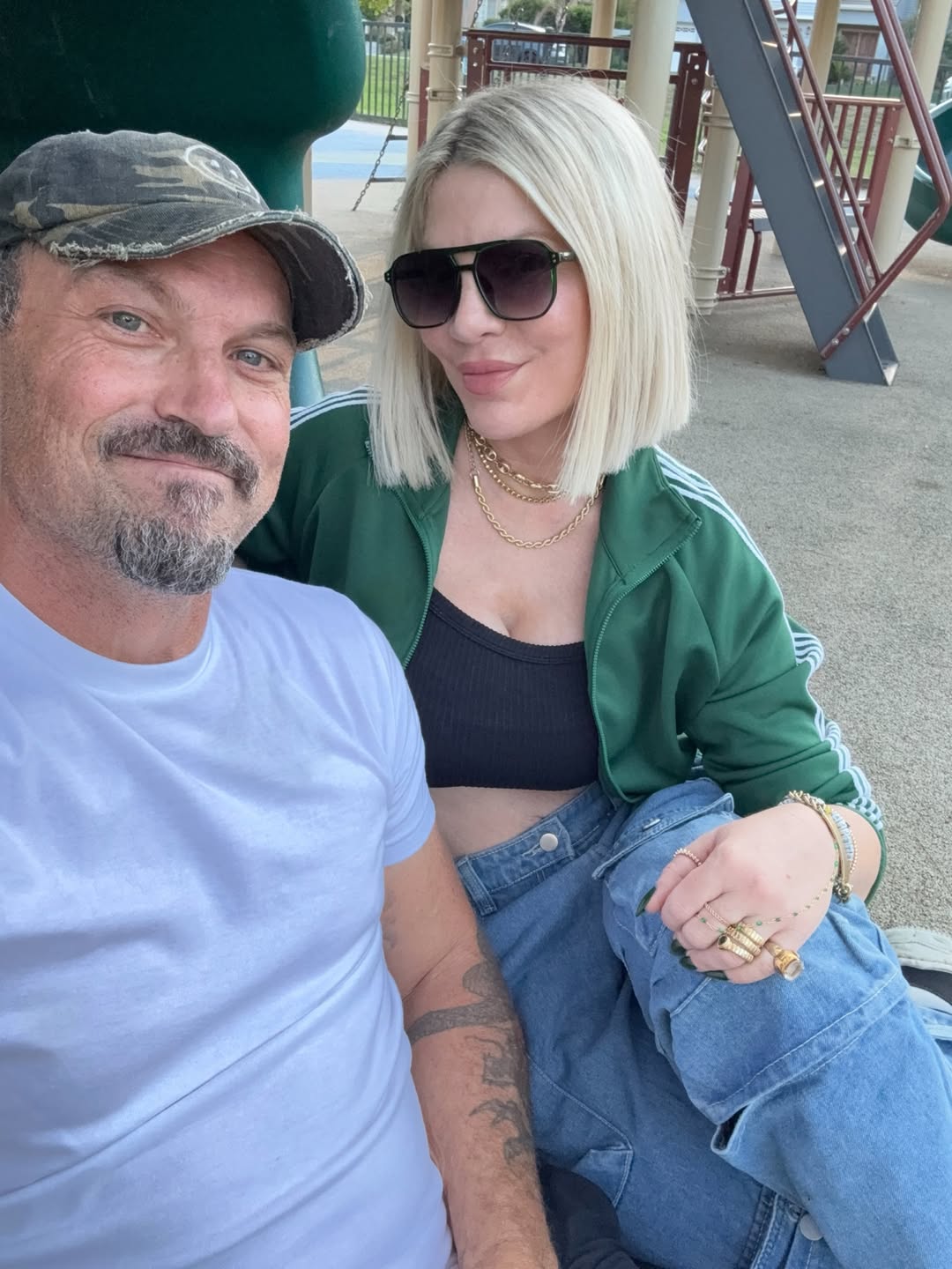 Tori Spelling and Brian Austin Green at a playground.