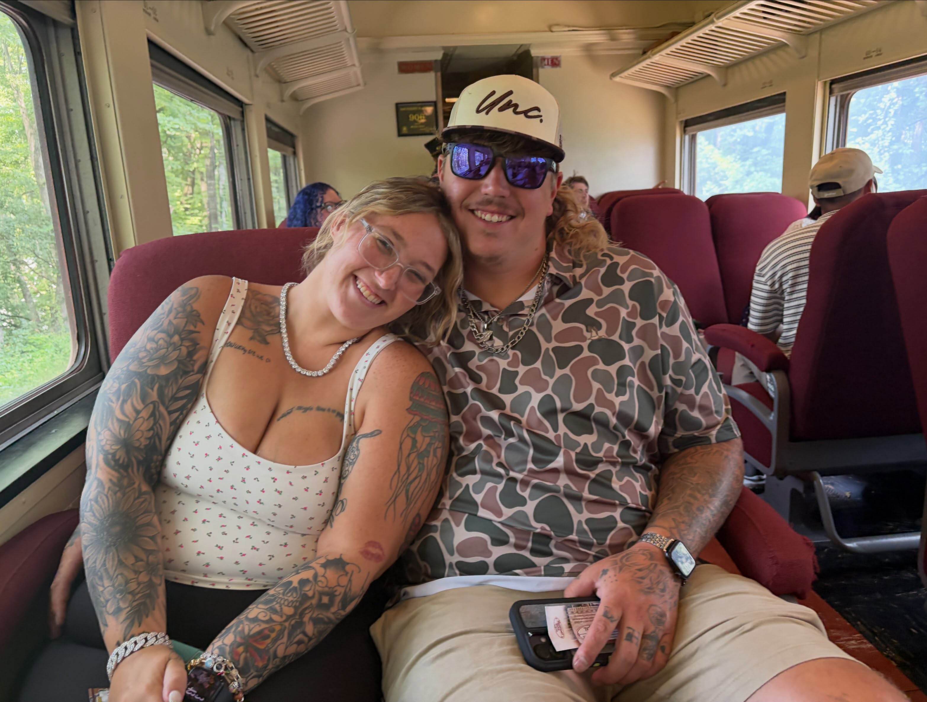 Pumpkin and Darrin Kitchens smiling in a train car.