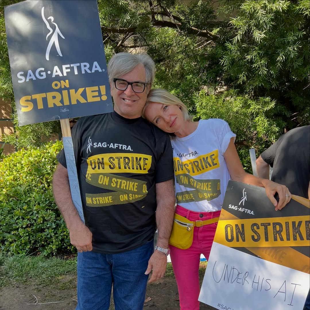 Robert and Ever Carradine holding "SAG-AFTRA ON STRIKE!" signs during the SAG-AFTRA strike.