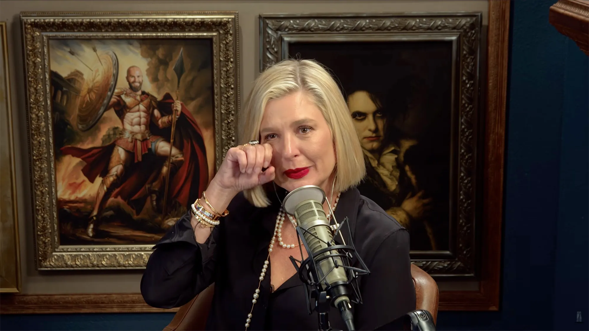 Christina Pazsitzky crying and wiping a tear from her eye.