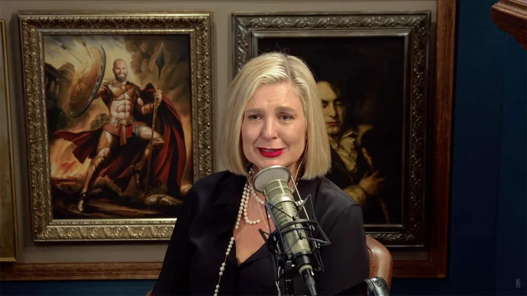Christina Pazsitzky crying into a microphone.