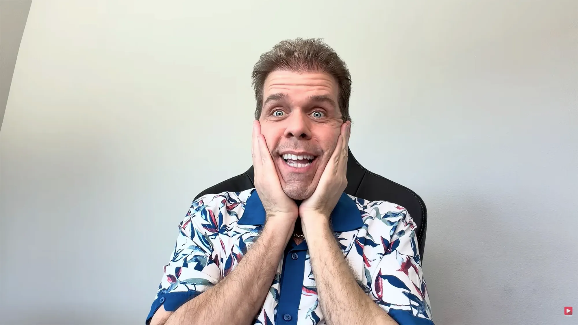 Perez Hilton with hands on his cheeks and a wide-eyed, open-mouthed expression.