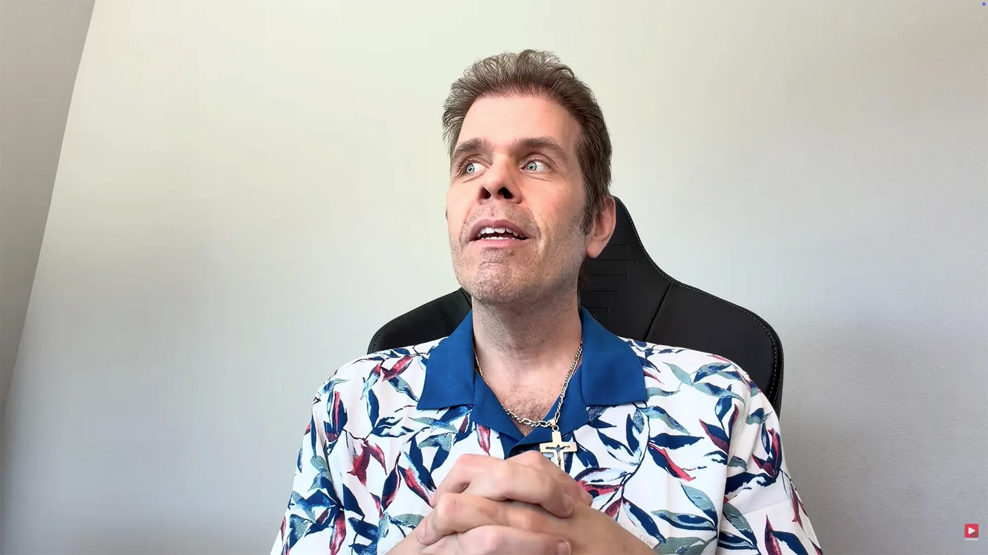 Perez Hilton in a floral shirt, looking up and to the left.