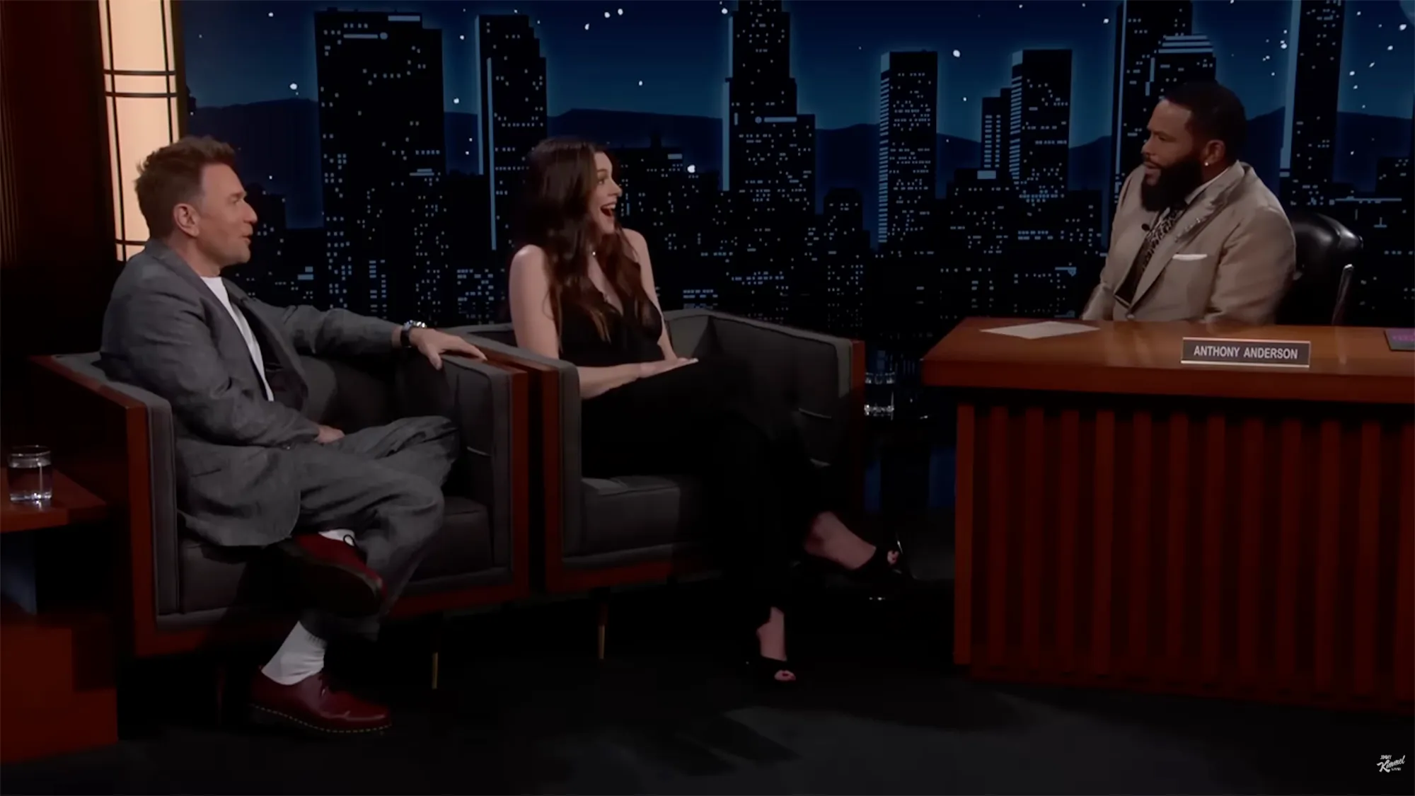 Ewan McGregor and Mary Elizabeth Winstead seated on a talk show set with host Anthony Anderson.