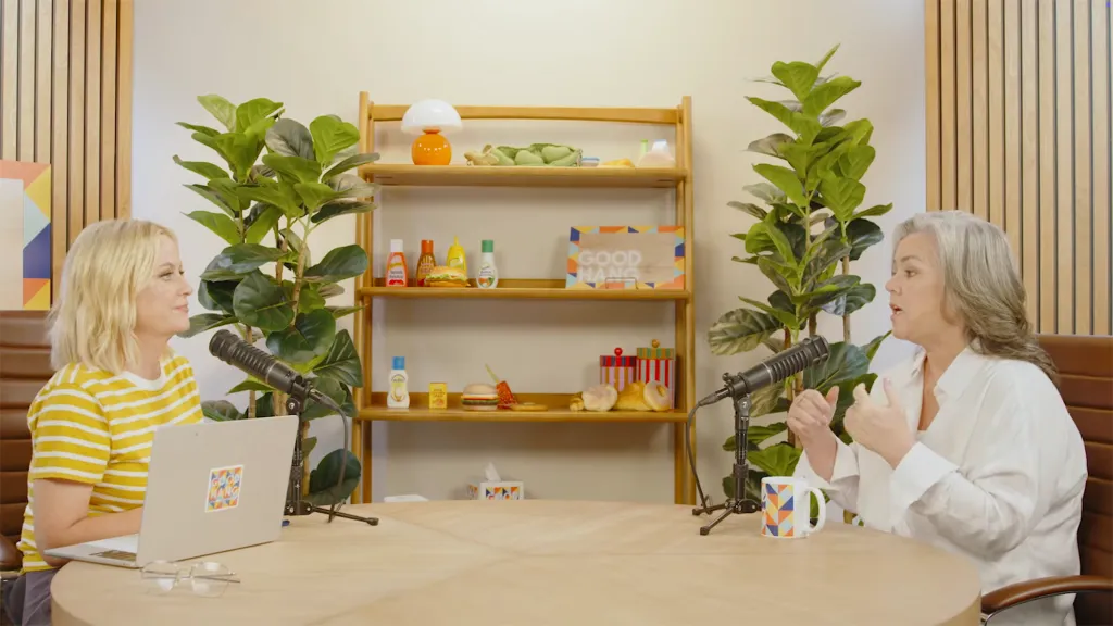 Amy Poehler interviewing Rosie O'Donnell on a podcast.